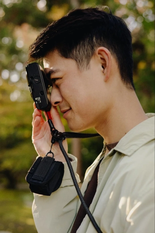 男性が小型カメラを構えている